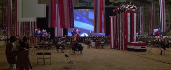 Movie still from “The People vs. Larry Flynt” (1996), directed by Milos Forman – A crowd of people sitting in chairs in front of a large screen; Extreme Wide shot, High angle