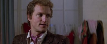 Movie still from “The People vs. Larry Flynt” (1996), directed by Milos Forman – A person wearing a suit and tie; Close Up shot, Over the shoulder angle