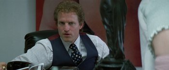 Movie still from “The People vs. Larry Flynt” (1996), directed by Milos Forman – A person wearing a vest and a tie; Close Up shot, Low angle
