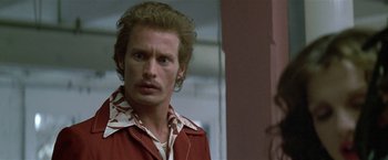 Movie still from “The People vs. Larry Flynt” (1996), directed by Milos Forman – A person wearing a red shirt; Close Up shot, Over the shoulder angle
