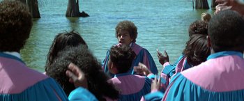 Movie still from “The People vs. Larry Flynt” (1996), directed by Milos Forman – A group of people standing in front of a body of water; Medium shot, High angle