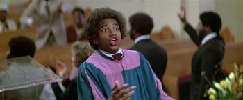 Movie still from “The People vs. Larry Flynt” (1996), directed by Milos Forman – A man in a choir robe talking to a group of people; Close Up shot, Low angle