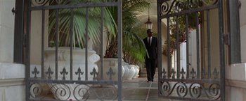 Movie still from “The People vs. Larry Flynt” (1996), directed by Milos Forman – A man in a black suit walking down a sidewalk; Wide shot, Low angle