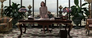 Movie still from “The People vs. Larry Flynt” (1996), directed by Milos Forman – A woman standing in front of a desk in a room; Wide shot, Low angle