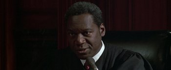 Movie still from “The People vs. Larry Flynt” (1996), directed by Milos Forman – A person wearing a suit and tie; Close Up shot, Low angle