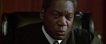 Movie still from “The People vs. Larry Flynt” (1996), directed by Milos Forman – A person wearing a suit and tie; Close Up shot, Low angle