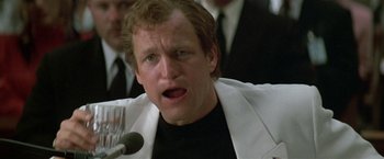 Movie still from “The People vs. Larry Flynt” (1996), directed by Milos Forman – A person with a microphone in a room; Close Up shot, Low angle
