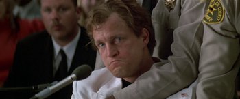 Movie still from “The People vs. Larry Flynt” (1996), directed by Milos Forman – A person sitting in front of microphones; Close Up shot, Low angle