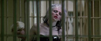 Movie still from “The People vs. Larry Flynt” (1996), directed by Milos Forman – A woman in a black dress is behind bars; Close Up shot, Low angle