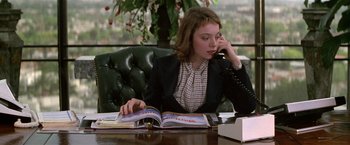 Movie still from “The People vs. Larry Flynt” (1996), directed by Milos Forman – A woman sitting at a table talking on the phone; Medium shot, Low angle