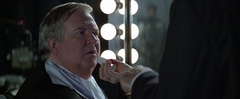 Movie still from “The People vs. Larry Flynt” (1996), directed by Milos Forman – A man putting lipstick on another man's face; Close Up shot, Over the shoulder angle