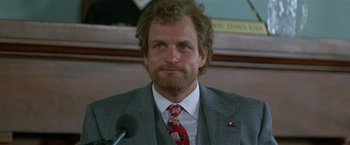 Movie still from “The People vs. Larry Flynt” (1996), directed by Milos Forman – A person wearing a suit and tie; Close Up shot, Low angle