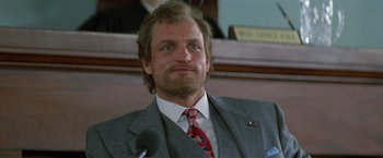 Movie still from “The People vs. Larry Flynt” (1996), directed by Milos Forman – A person wearing a suit and tie; Close Up shot, Low angle