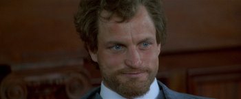 Movie still from “The People vs. Larry Flynt” (1996), directed by Milos Forman – A person wearing a suit and tie; Close Up shot, Over the shoulder angle