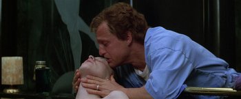 Movie still from “The People vs. Larry Flynt” (1996), directed by Milos Forman – A man kissing a woman on the cheek; Close Up shot, Low angle