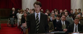 Movie still from “The People vs. Larry Flynt” (1996), directed by Milos Forman – A man in a black suit is giving a speech; Medium shot, High angle