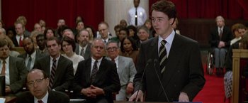 Movie still from “The People vs. Larry Flynt” (1996), directed by Milos Forman – A man in a business suit is giving a speech; Medium shot, Low angle