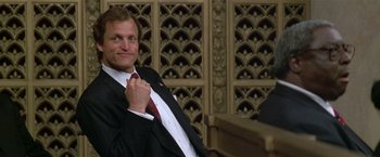 Movie still from “The People vs. Larry Flynt” (1996), directed by Milos Forman – A man in a black suit and a red tie; Medium shot, Low angle