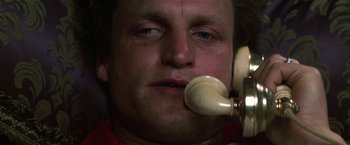 Movie still from “The People vs. Larry Flynt” (1996), directed by Milos Forman – A man with his mouth on a phone; Close Up shot, Low angle