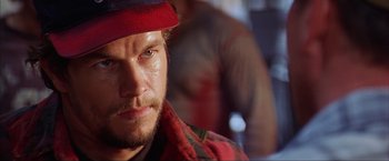Movie still from “The Perfect Storm” (2000), directed by Wolfgang Petersen – A person wearing a hat; Close Up shot, Over the shoulder angle