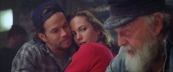 Movie still from “The Perfect Storm” (2000), directed by Wolfgang Petersen – A man and a woman hugging each other in front of another man; Close Up shot, Over the shoulder angle