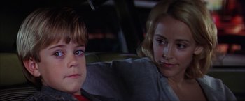 Movie still from “The Perfect Storm” (2000), directed by Wolfgang Petersen – A young boy sitting next to a young woman in a car; Close Up shot, Over the shoulder angle