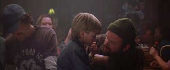 Movie still from “The Perfect Storm” (2000), directed by Wolfgang Petersen – A young boy and an older man touching each other's face; Close Up shot, Over the shoulder angle