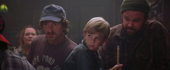 Movie still from “The Perfect Storm” (2000), directed by Wolfgang Petersen – A young boy holding a pencil in front of two other people; Close Up shot, Low angle
