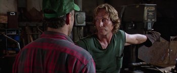 Movie still from “The Perfect Storm” (2000), directed by Wolfgang Petersen – A man in a green shirt is talking to another man in a green hat; Close Up shot, Over the shoulder angle