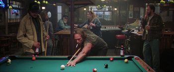Movie still from “The Perfect Storm” (2000), directed by Wolfgang Petersen – A man is playing pool while a woman watches; Medium shot, Over the shoulder angle