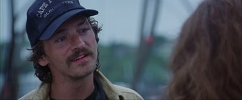 Movie still from “The Perfect Storm” (2000), directed by Wolfgang Petersen – A person wearing a hat; Close Up shot, Over the shoulder angle
