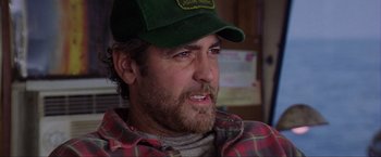 Movie still from “The Perfect Storm” (2000), directed by Wolfgang Petersen – A person wearing a hat; Close Up shot, Over the shoulder angle