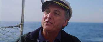 Movie still from “The Perfect Storm” (2000), directed by Wolfgang Petersen – A person wearing a hat on a boat; Close Up shot, Low angle