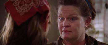 Movie still from “The Perfect Storm” (2000), directed by Wolfgang Petersen – An older woman looking into a mirror with a bandanna on her head; Close Up shot, Over the shoulder angle