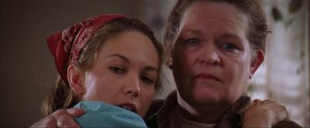 Movie still from “The Perfect Storm” (2000), directed by Wolfgang Petersen – A woman sitting next to another woman in front of a window; Close Up shot, Low angle