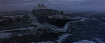 Movie still from “The Perfect Storm” (2000), directed by Wolfgang Petersen – A large cargo ship sailing in the middle of the ocean; Extreme Wide shot, Overhead angle