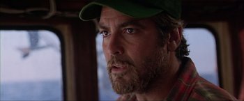 Movie still from “The Perfect Storm” (2000), directed by Wolfgang Petersen – A person with a beard wearing a hat; Close Up shot, Low angle