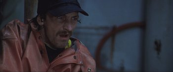 Movie still from “The Perfect Storm” (2000), directed by Wolfgang Petersen – A person wearing a hat and a jacket; Close Up shot, Low angle