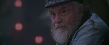 Movie still from “The Perfect Storm” (2000), directed by Wolfgang Petersen – An old man with a beard wearing a hat; Close Up shot, Over the shoulder angle