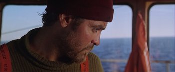 Movie still from “The Perfect Storm” (2000), directed by Wolfgang Petersen – A person wearing a hat on a boat; Close Up shot, Over the shoulder angle