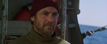 Movie still from “The Perfect Storm” (2000), directed by Wolfgang Petersen – A person wearing a hat; Close Up shot, Over the shoulder angle