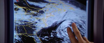 Movie still from “The Perfect Storm” (2000), directed by Wolfgang Petersen – A hand is pointing at a map of the world; Close Up shot, High angle