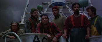 Movie still from “The Perfect Storm” (2000), directed by Wolfgang Petersen – A group of men standing next to each other on top of a boat; Medium shot, Low angle