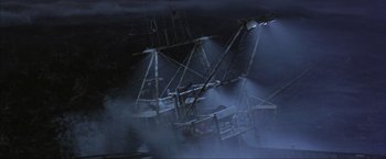 Movie still from “The Perfect Storm” (2000), directed by Wolfgang Petersen – A ship is in the fog at night time; Extreme Wide shot, High angle