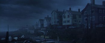 Movie still from “The Perfect Storm” (2000), directed by Wolfgang Petersen – A view of houses in the dark of a night; Extreme Wide shot, High angle