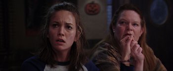 Movie still from “The Perfect Storm” (2000), directed by Wolfgang Petersen – Two women sitting next to each other in front of a pumpkin; Close Up shot, Over the shoulder angle