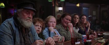Movie still from “The Perfect Storm” (2000), directed by Wolfgang Petersen – A group of people sitting at a table with money; Medium shot, Over the shoulder angle