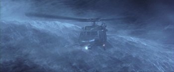 Movie still from “The Perfect Storm” (2000), directed by Wolfgang Petersen – A helicopter is flying through the air in the dark; Extreme Wide shot, High angle