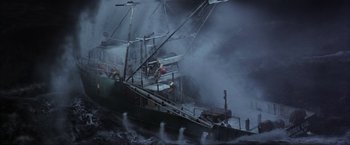 Movie still from “The Perfect Storm” (2000), directed by Wolfgang Petersen – A boat in the water with a lot of smoke coming out of it; Extreme Wide shot, High angle