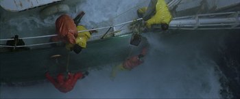 Movie still from “The Perfect Storm” (2000), directed by Wolfgang Petersen – A group of people on a raft in the water; Extreme Wide shot, Overhead angle